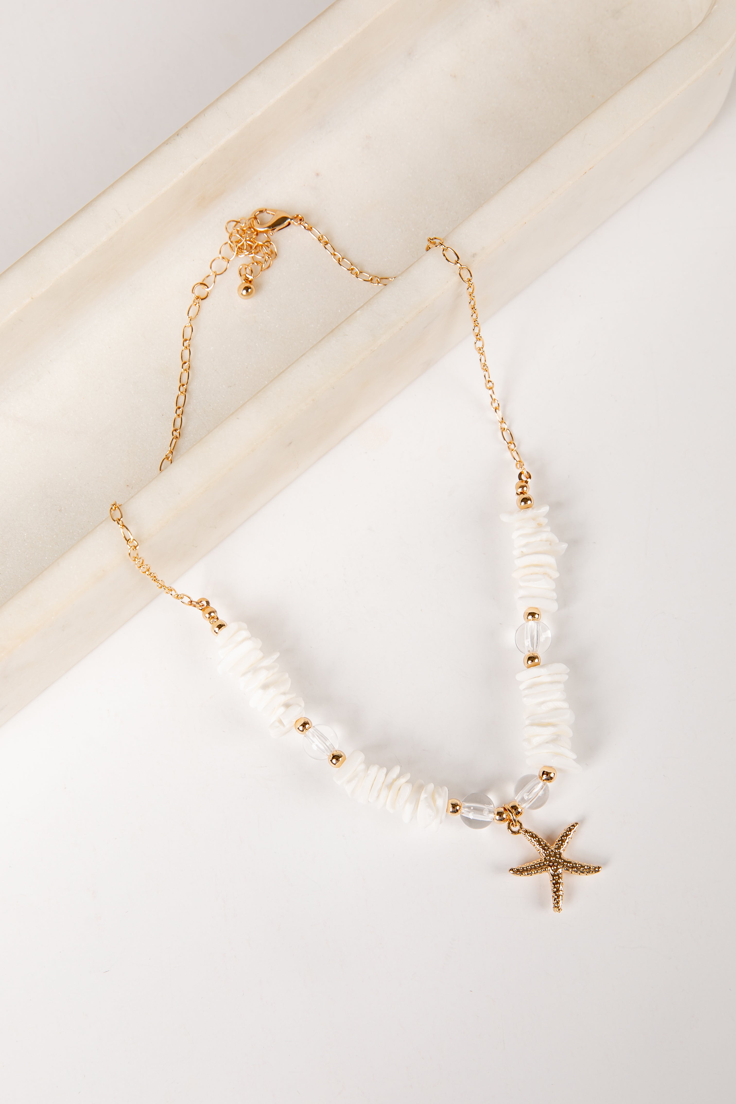 Necklace with starfish charm on a light background