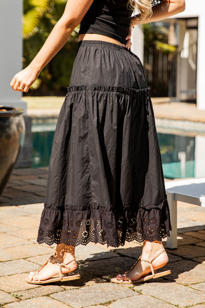 Black lace-trim maxi skirt walking shot