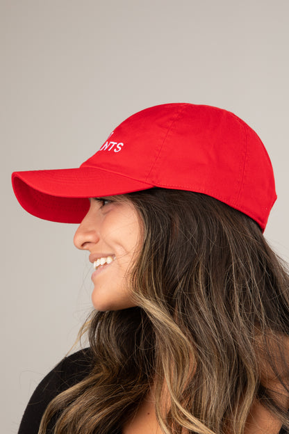Woman wearing a red cap with &