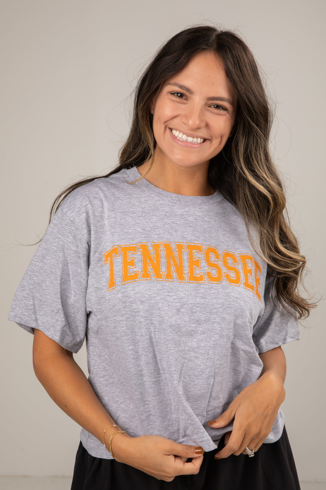 Woman wearing a gray t-shirt with &