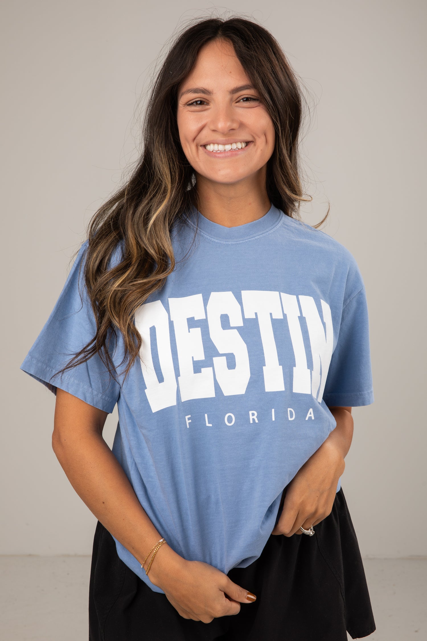 Woman wearing a blue t-shirt with &
