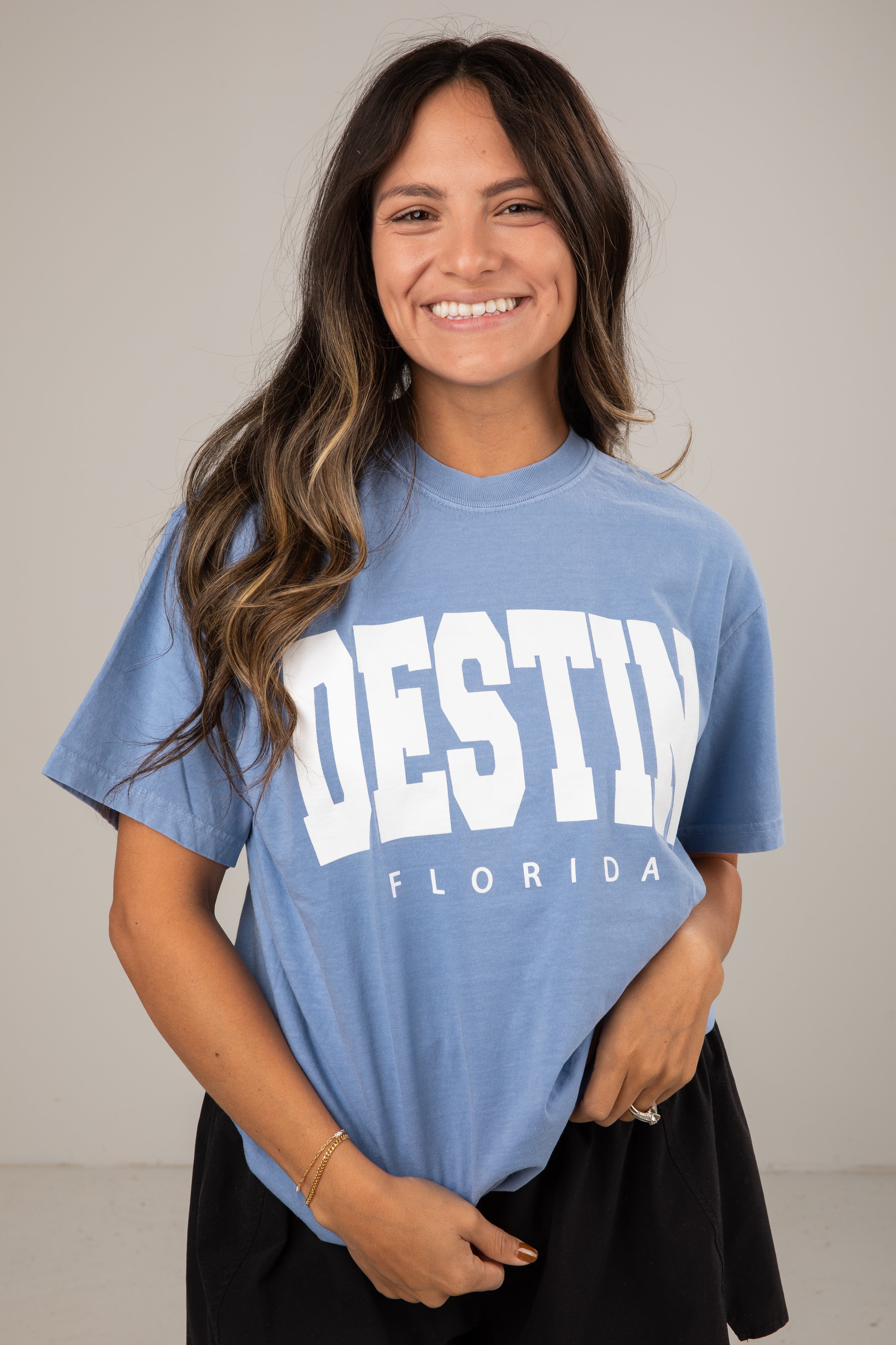 Woman wearing a blue t-shirt with &