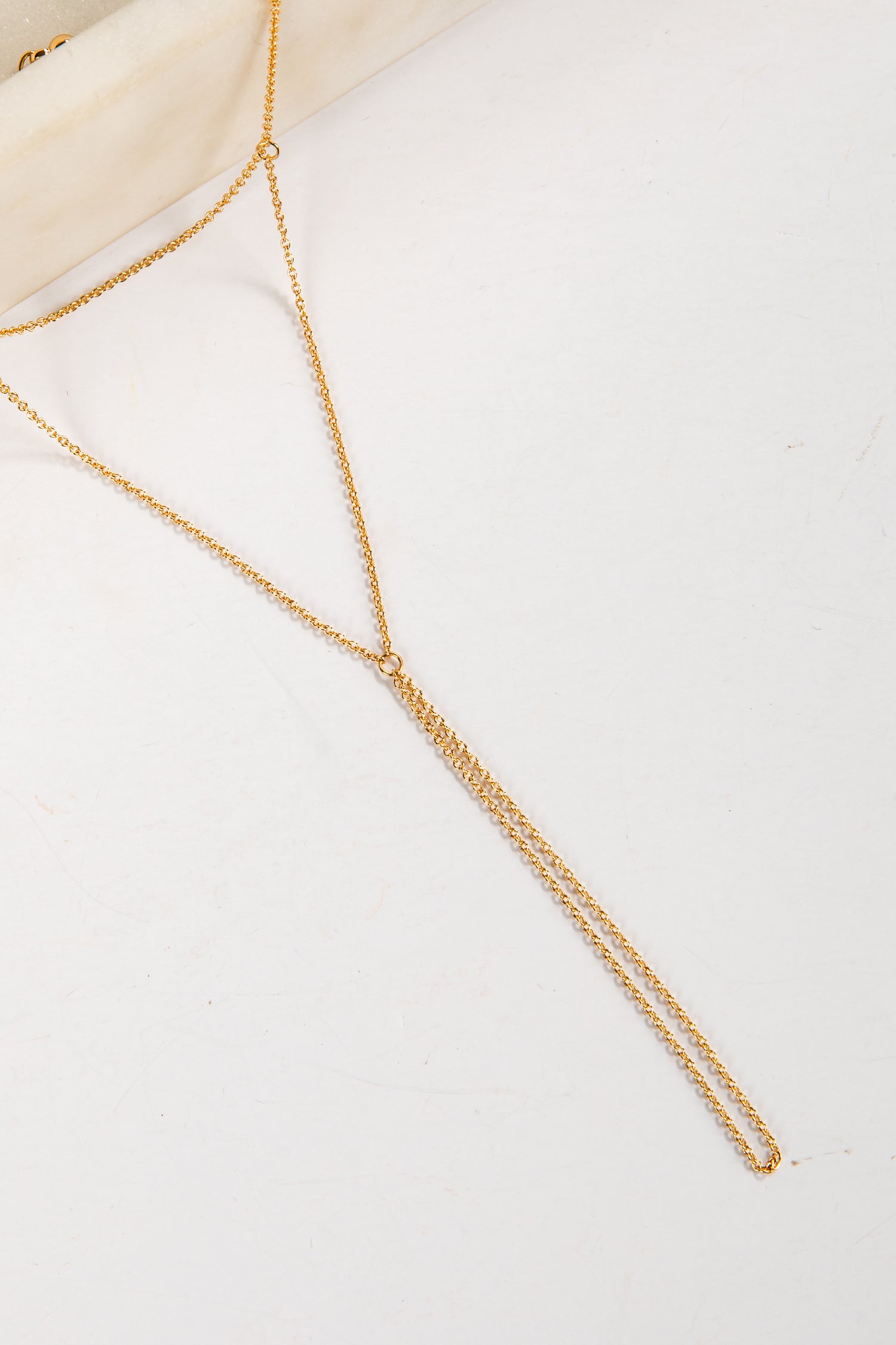 Gold body chain on a white background