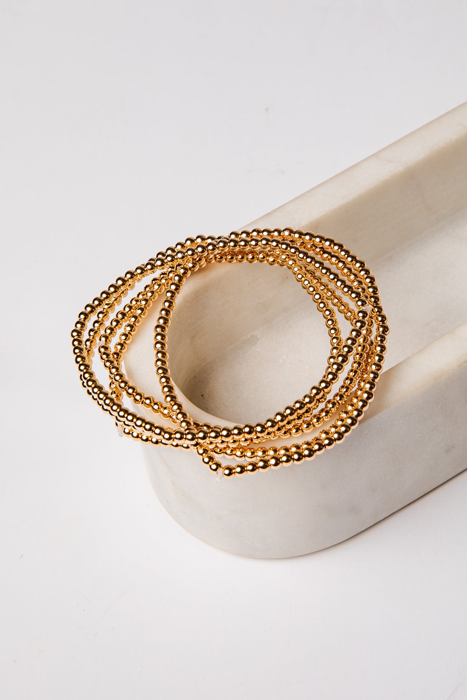 set of 5 gold beaded bracelets