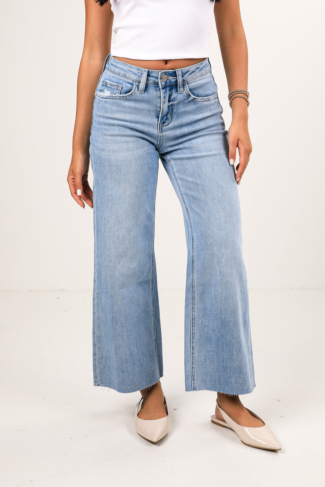 Light blue wide-leg jeans worn by a person on a white background