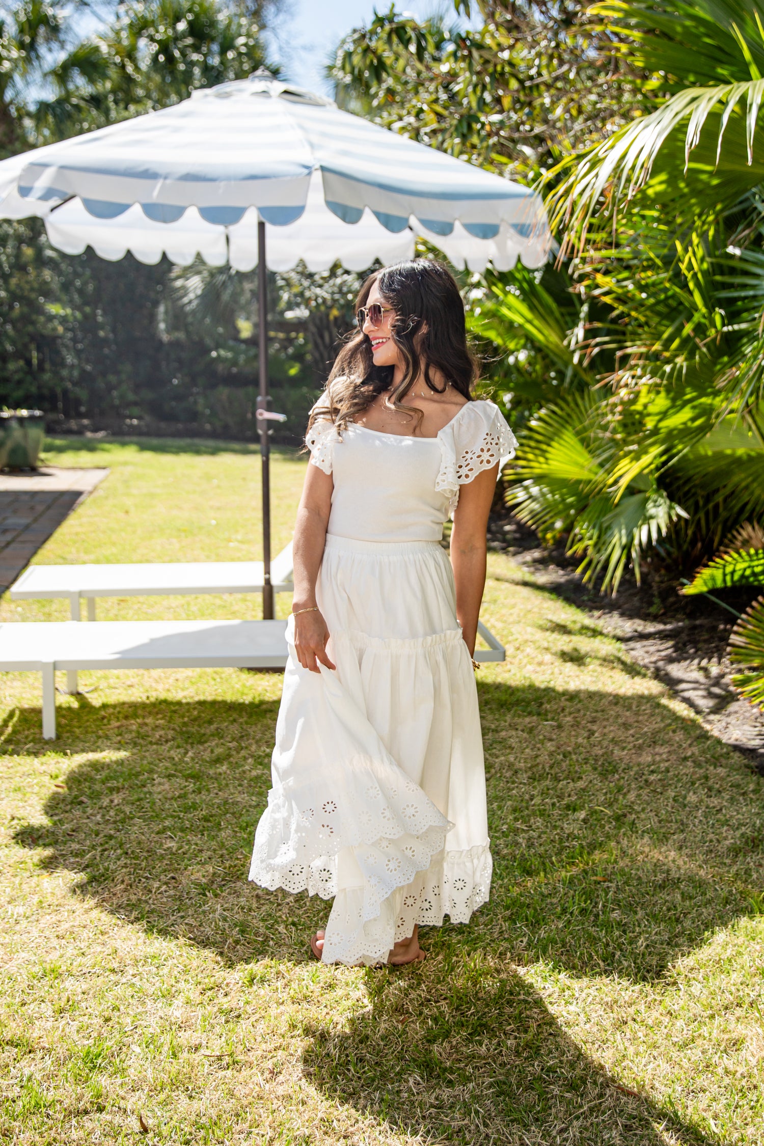 White flowy maxi skirt styled in garden